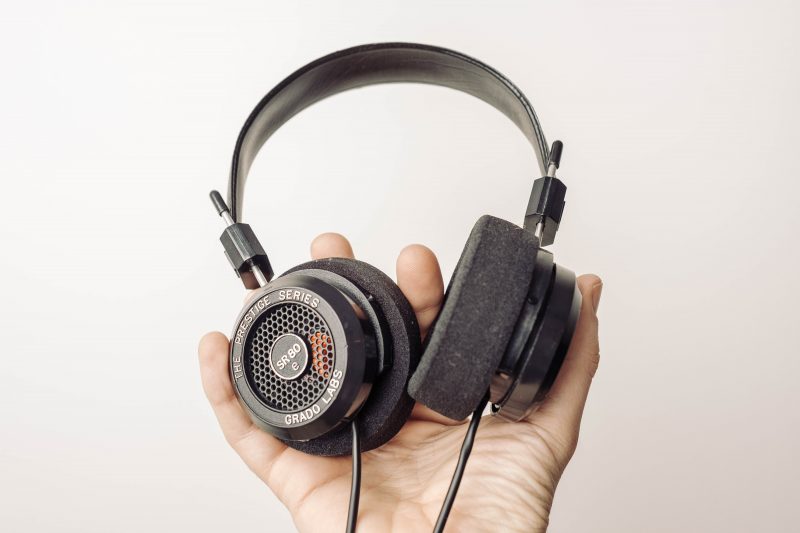 headphones, hand, holding headphones